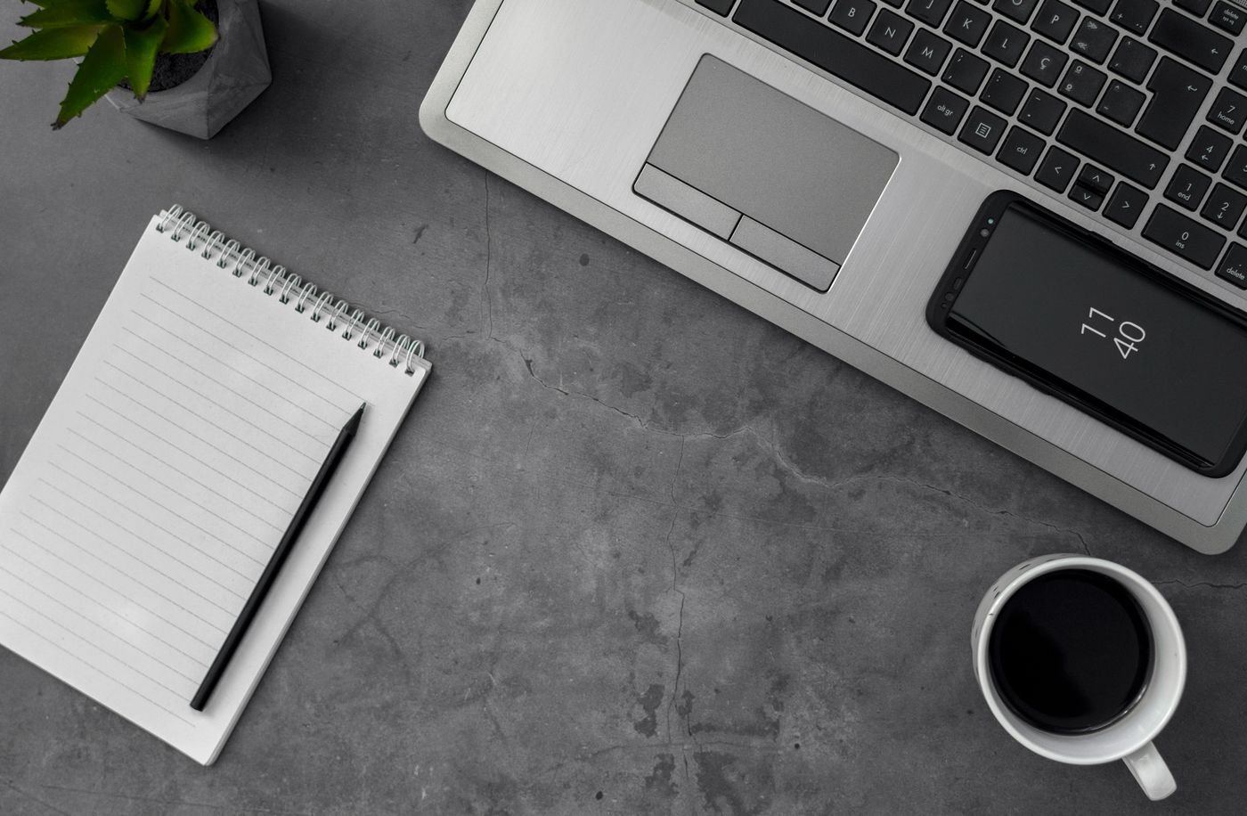 Services Laptop, notebook and coffee on a desk